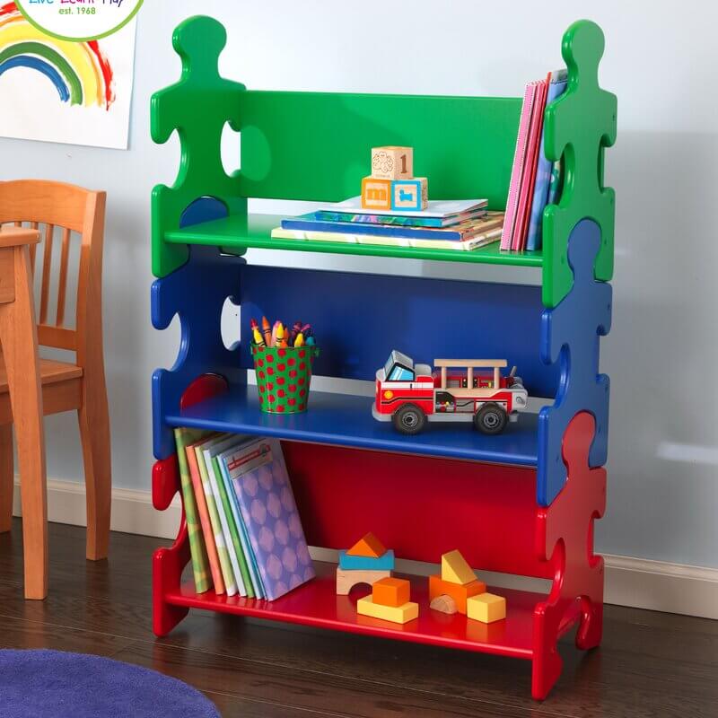 Multicolored bookshelf that is shaped as puzzle pieces.